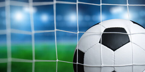 Soccer ball in goal on stadium