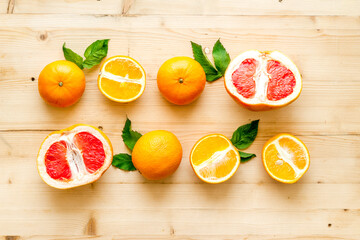 Grapefruits and oranges on wood top view
