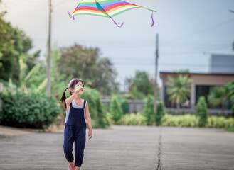 Close-up view of cute girl playing with sports (kite sport), learning outside the classroom during the summer semester and making good use of leisure time.