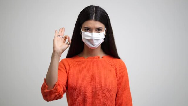 Beautiful confident young Caucasian girl with surgical mask . Covid-19 coronavirus. Professional student girl close up front portrait. Isolate 