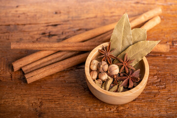 Spices and herbs ingredients for cooking Curry, Curry powder, clove, cardamom, cinnamon, caraway on wooden background.