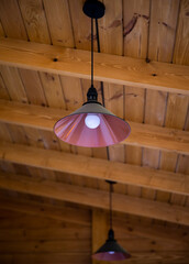 round metal chandelier on the wood ceiling