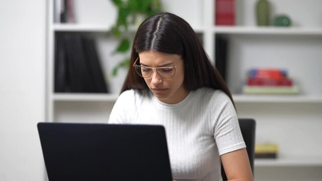 young girl works on the computer in her office