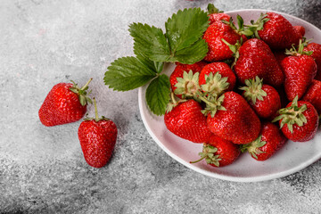 Beautiful juicy fresh strawberries on the concrete surface of the table