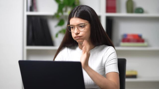 young girl works on the computer in her office
