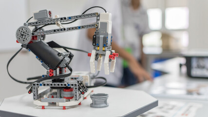 Robotic lab class with school students blur background in AI learning or group study workshop in...