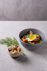 Salad with fresh vegetables  with red beans,  tomatoes,  dill, half egg,  toast Close up view