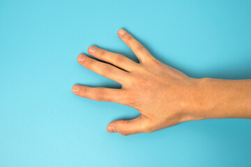 Close up of man's hand isolated on blue background
