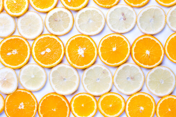 Flat lay view of orange and lemon slices on white backround.