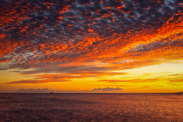 Fototapeta na wymiar 【ハワイ】ワイキキビーチから見る夕方の赤く染まる海と空