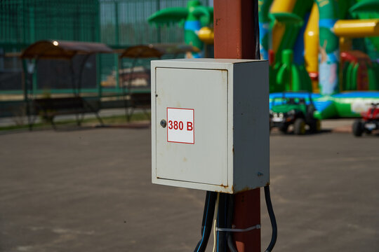 Electric meter 380 V. Gray box on a pole. Street electricity. High quality photo
