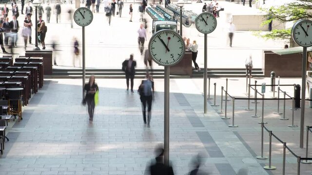 Time lapse footage of clock faces and people commuting, Docklands, London
