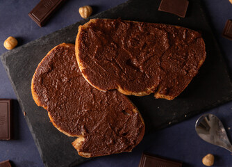Homemade cocoa cream toast on a dark blue background