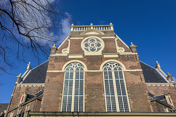 Fototapeta na wymiar View of Northern church (Noorderkerk) - XVII century Protestant church in Amsterdam. Noorderkerk is located along Prinsengracht canal, on the Noordermarkt square. Amsterdam, Netherlands.
