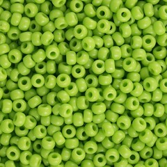 Round seed bead in opaque lime usable for background