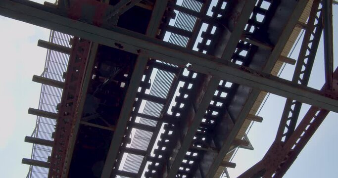Underneath subway tracks in Brooklyn with dust and particles falling down through light