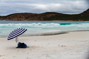 A striped lone umbrella on a deserted beach, Esperance, Western Australia