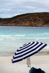 A striped lone umbrella on a deserted beach, Esperance, Western Australia