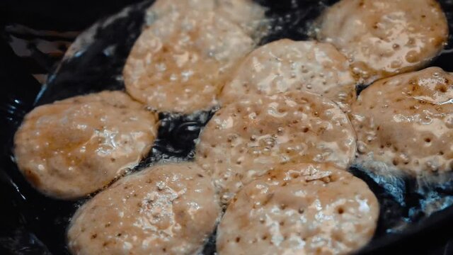 Close up shot of Indian puri being fried in oil