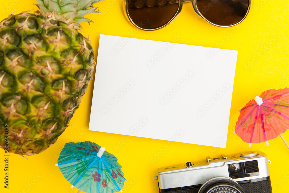 Wall mural summertime background blank card with pineapple sunglasses and cocktail umbrella