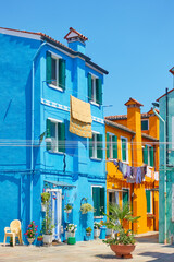 Fototapeta na wymiar Street with old multicolored houses with in Burano in Venice