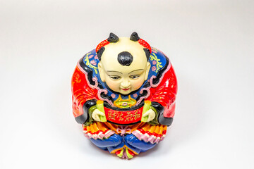 Chinese-style pottery doll appealing for savings isolated on white background.