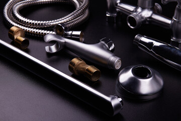 Plumbing tools on black background. Sanitary engineering