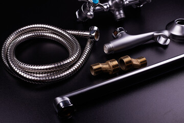 Plumbing tools on black background. Sanitary engineering