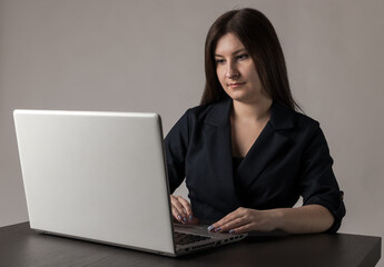 Young woman in blue with laptop.