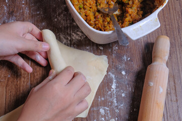 Woman making curry puff.