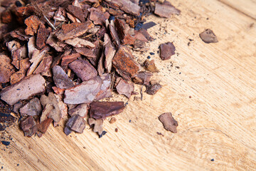 Dry pine bark for transplanting orchids of other plants. The substrate for orchids. Soil for mulching. Orchid transplant at home. Preparing for a houseplant transplant.