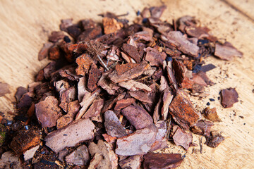 Dry pine bark for transplanting orchids of other plants. The substrate for orchids. Soil for mulching. Orchid transplant at home. Preparing for a houseplant transplant.