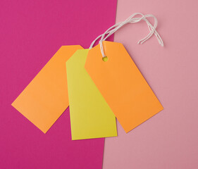 paper rectangular tags on a rope on a colored background