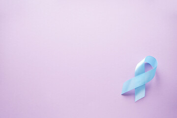 The blue ribbon on a pink background, flat lay. World diabetes day, 14 november. Space for text.