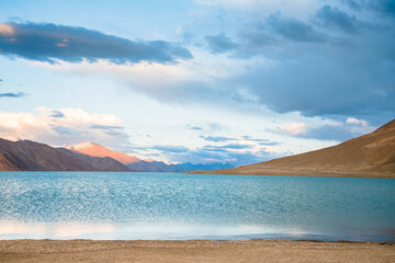Landscape image of Pangong lake and mountains view background in Ladakh, India. Pangong is an endorheic lake in the Himalayas situated at a height of about 4,350 m.