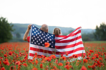 Couple holding the american flag on the 4th of July