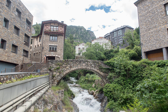 River Madriu on La Tosca Bridge and houses view in a snowfall day in small town Escaldes-Engordany in Andorra on juny 2020.