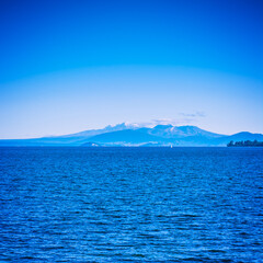 Volcanic cones of Ruapehu towering over great lake of Taupo on a beautiful sunny day. Natural background. North Island Volcanic Plateau, New Zealand