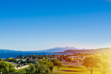 Autumn evening over Taupo city and lake. Ruapehu mountain at the horizon. North Island Volcanic...