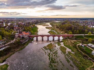 Areal drone photo view of old brick bridge over river Venta.