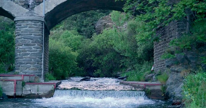 waters of the Trevelez river passing under a bridge