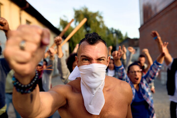 Angry rebel taking a part in violent public demonstrations on city streets.