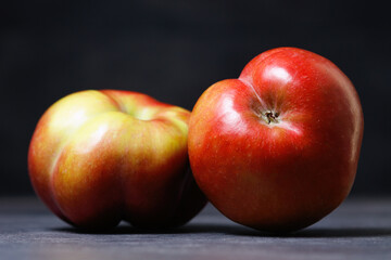 Two Red apple on dark background. Fruit shape sexuality concept. Selective focus