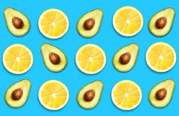 Seamless pattern with citrus fruits. Avocado and lemon on blue color background. Space for text. Top view fruit minimal concept.