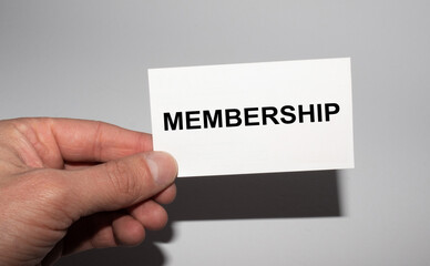 Message on the card MEMBERSHIP, in hands of businessman.