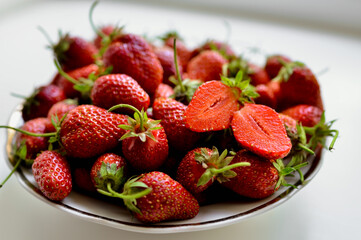 Red strawberries on a white background. Juicy strawberry in a cut. Natural eco-product.