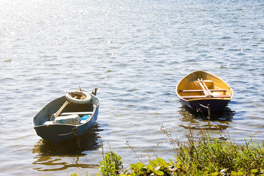 Summer lake and boats. Dramatic sky with clouds.