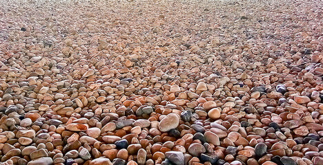 Colorful pebble stone texture on the ground. Nature stone background