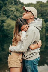 Fototapeta premium Young couple hugging in a natural lake.