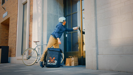 Food Delivery Man Wearing Thermal Backpack on Bike Delivers Restaurant Order, Leaving it Under the...
